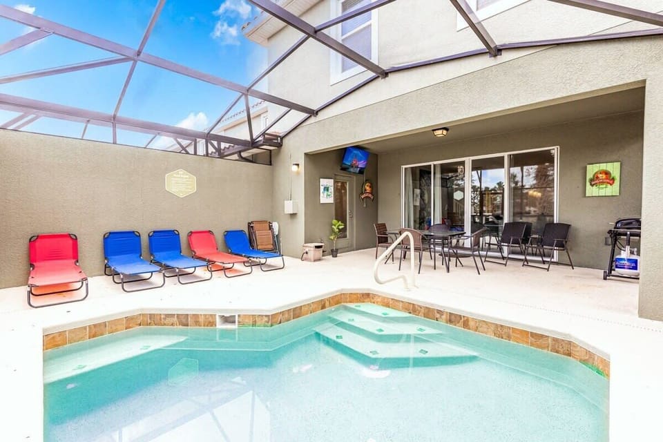 Private heatable inground pool with dining and seating on the covered patio.