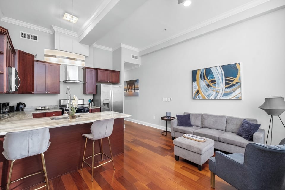 Open-concept living and dining area with hardwood floors and kitchen access maximizing space.