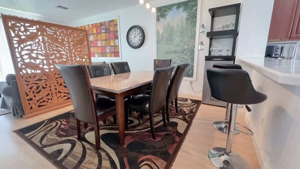 Comfortably seats six at the dining table, with additional seating for two at the counter stools.