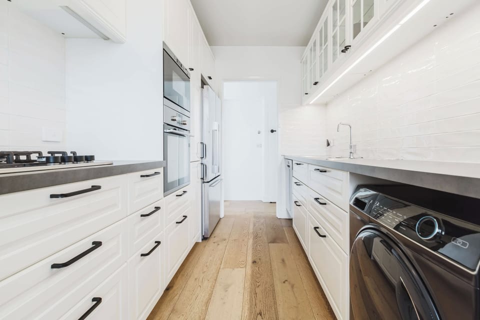 Galley-style kitchen with all the mod cons you'd expect to find as well as underbench Laundry facilities - washing machine and dryer.