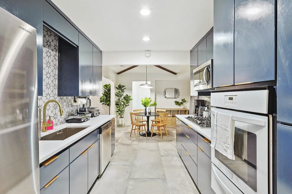 With the best of functionality and elegance, this gallery-style kitchen is fully equipped for all your culinary wishes with its top-notch appliances and luxury finishes.