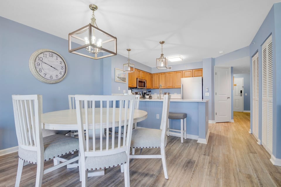 Enjoy meals in this bright, open space where your dining area flows into a fully-equipped kitchen, perfect for cooking and entertaining.