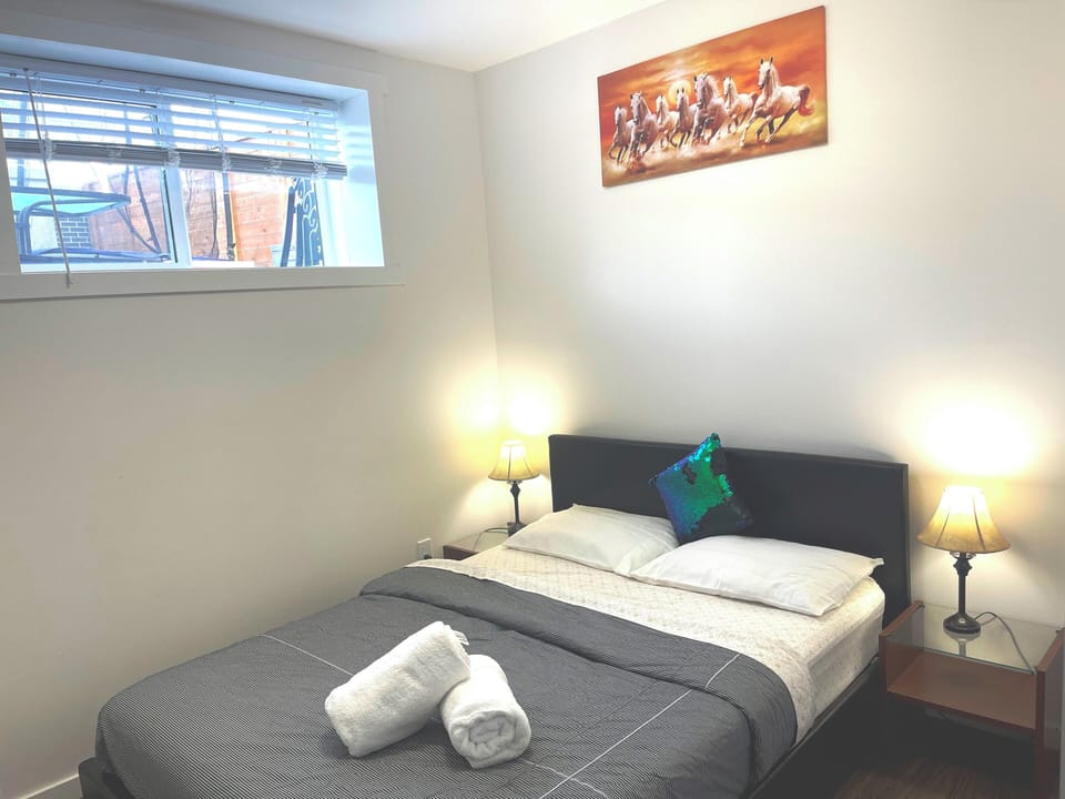 Bedroom 2 with queen bed, night lamps and closet
