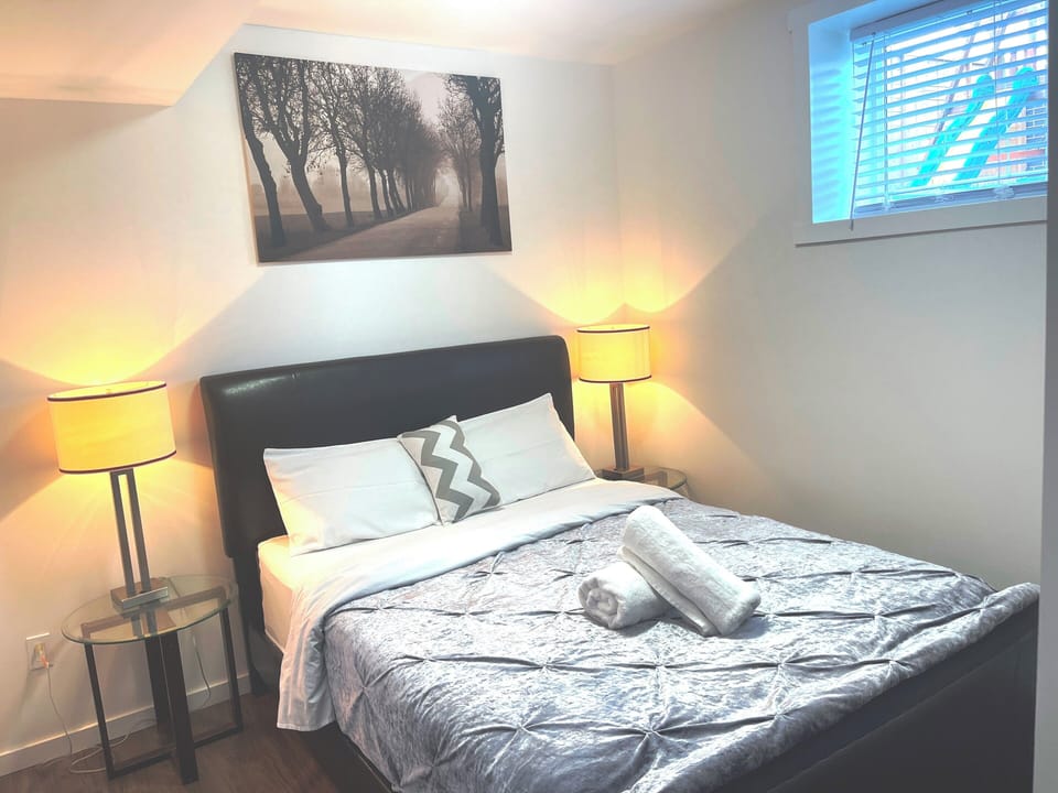 Bedroom 1 with queen bed, night lamps and closet