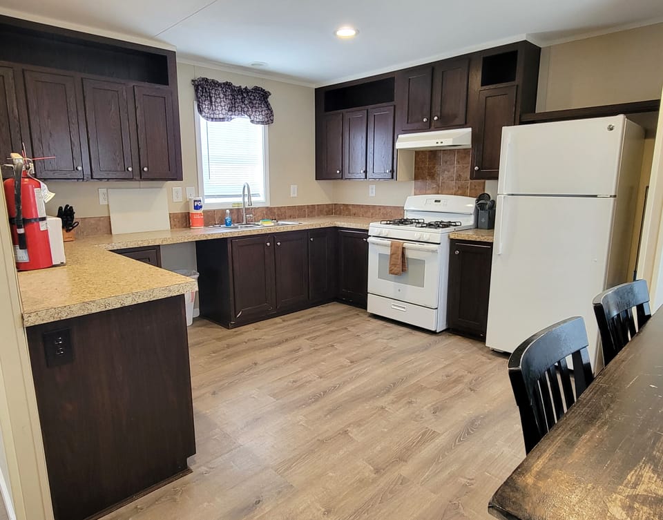 The full kitchen has a gas stove, refrigerator, microwave, and much more.