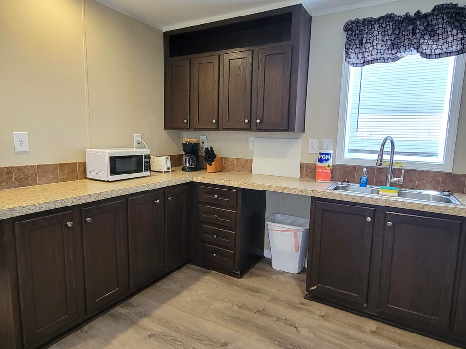 There is also a microwave, toaster, and plenty of storage and prep space.