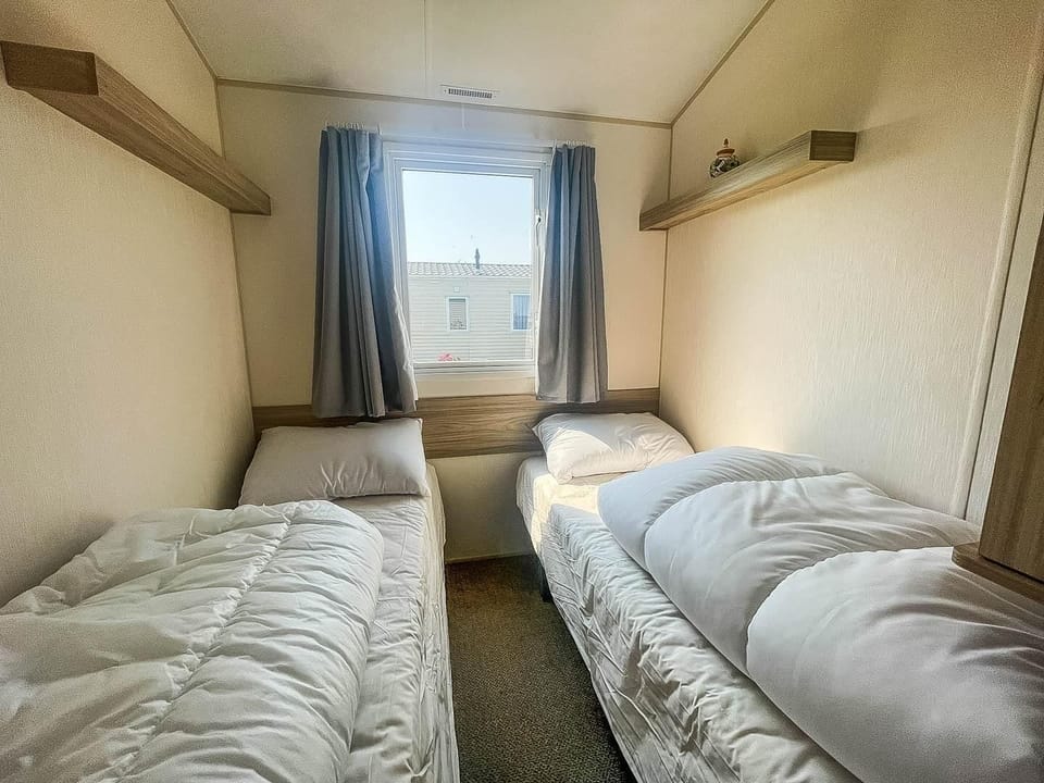 Practical twin caravan bedroom, designed to offer comfort and functionality for your UK travels!