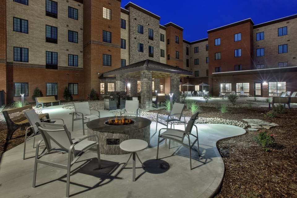 Outdoor fire pit with comfortable seating under the evening sky.