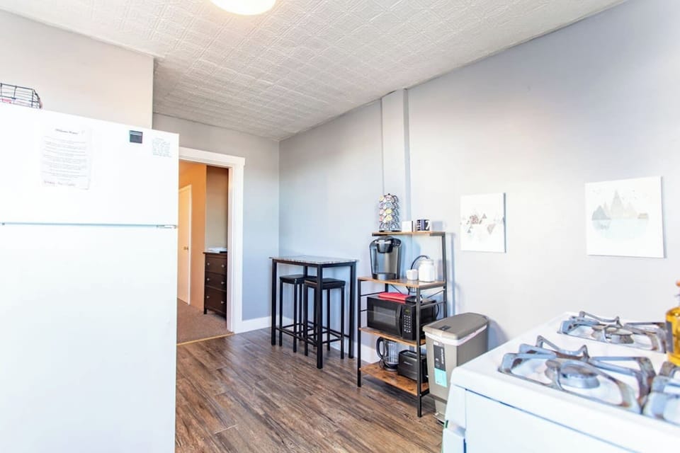Kitchen with a bistro table for dining and a coffee bar.