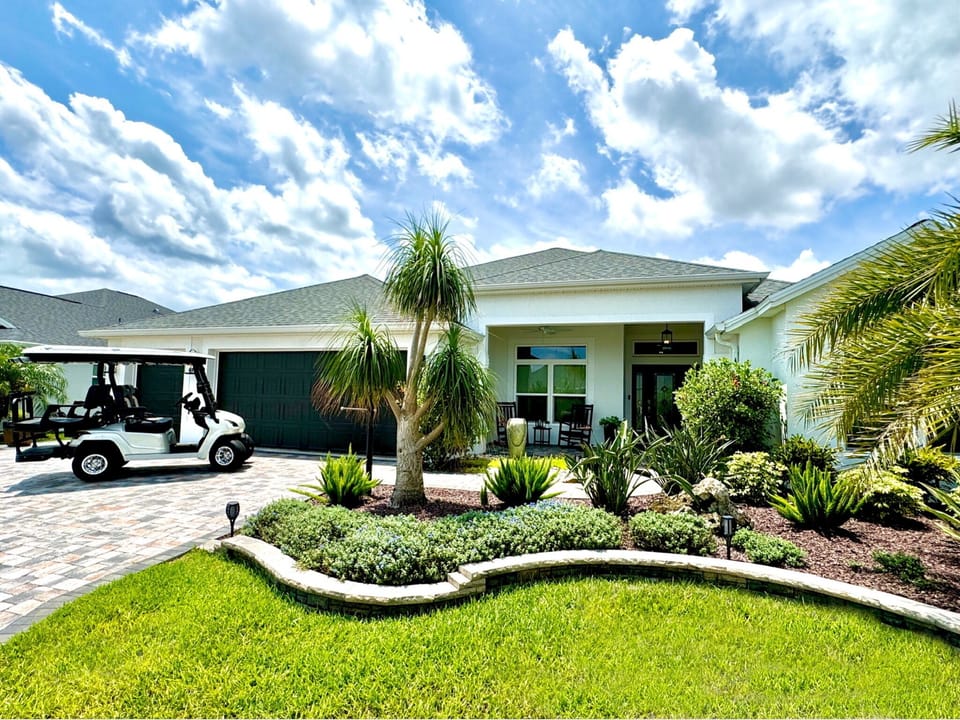A unique, 4 bedroom / 3 full bathroom, luxury designer home in one of the best locations in The Villages! 4-seater golf cart included with your stay.