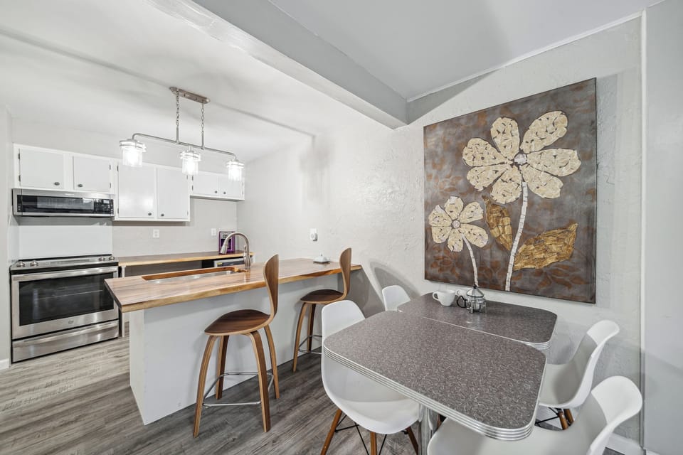 Morning Glory Apartment offers diner-style seating and two bar stools at the kitchen island.