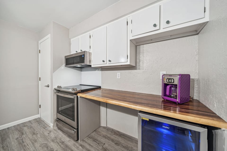 The kitchen features a 30 plus inch work space with 34" counter height for greater accessibility. There is an accessible mini-fridge under the counter.