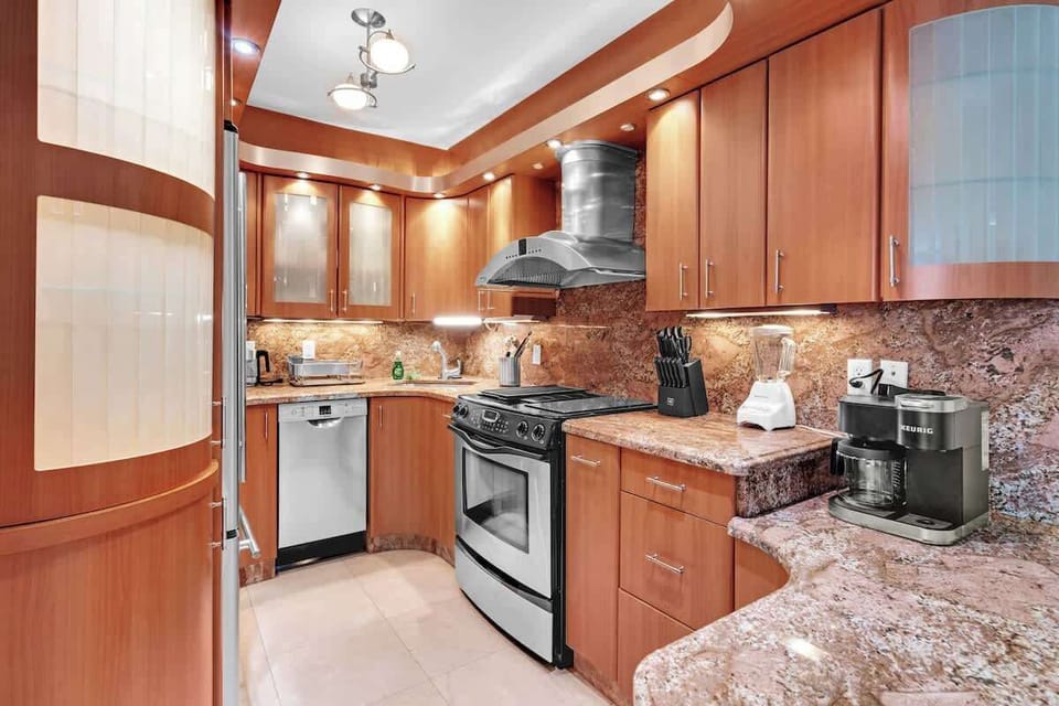Gather around in this chic Airbnb—modern kitchen, cozy dining, and classic touches for a memorable stay.