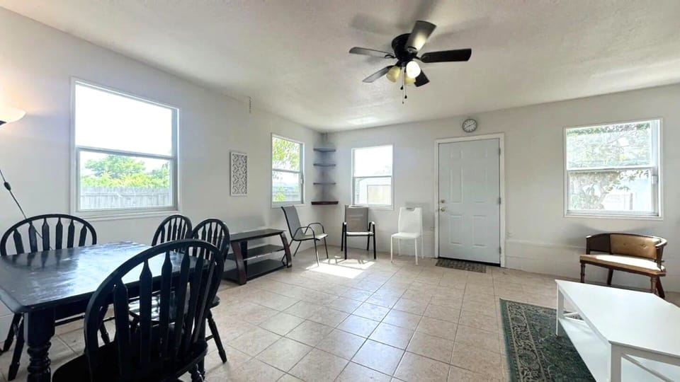 Living Room 2: Ample seating,meeting table,ceiling fan,huge windows,patio access