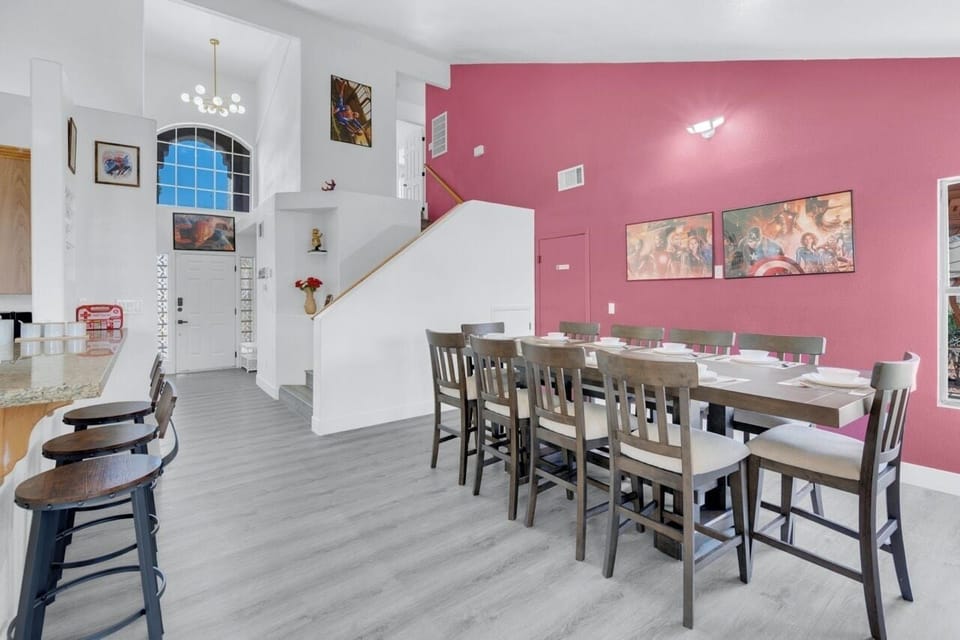 10-seat table, high ceiling, daylit, open access to kitchen and backyard