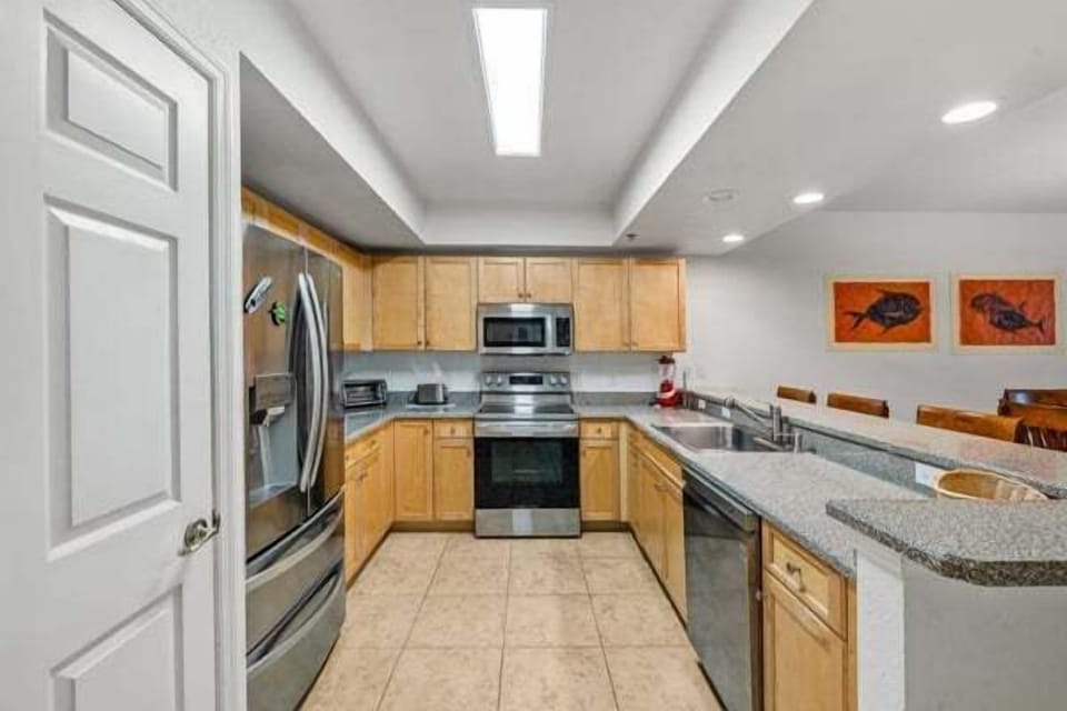 Well-equipped kitchen with bar seating and modern appliance