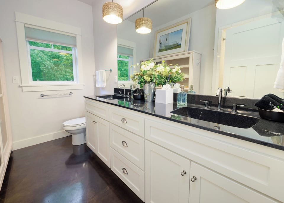 Bathroom with dual sinks and shower