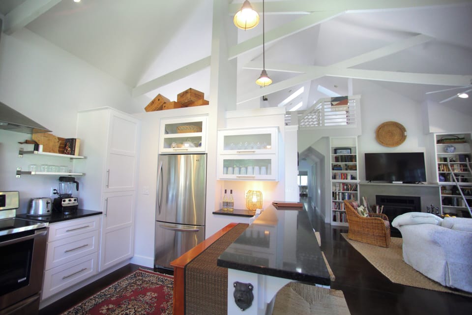 Open concept kitchen, unique architecture, and cozy furnishings