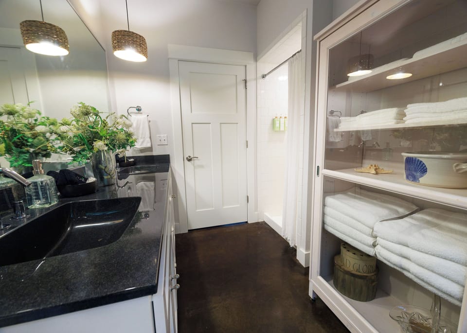 Bathroom with dual sinks and shower