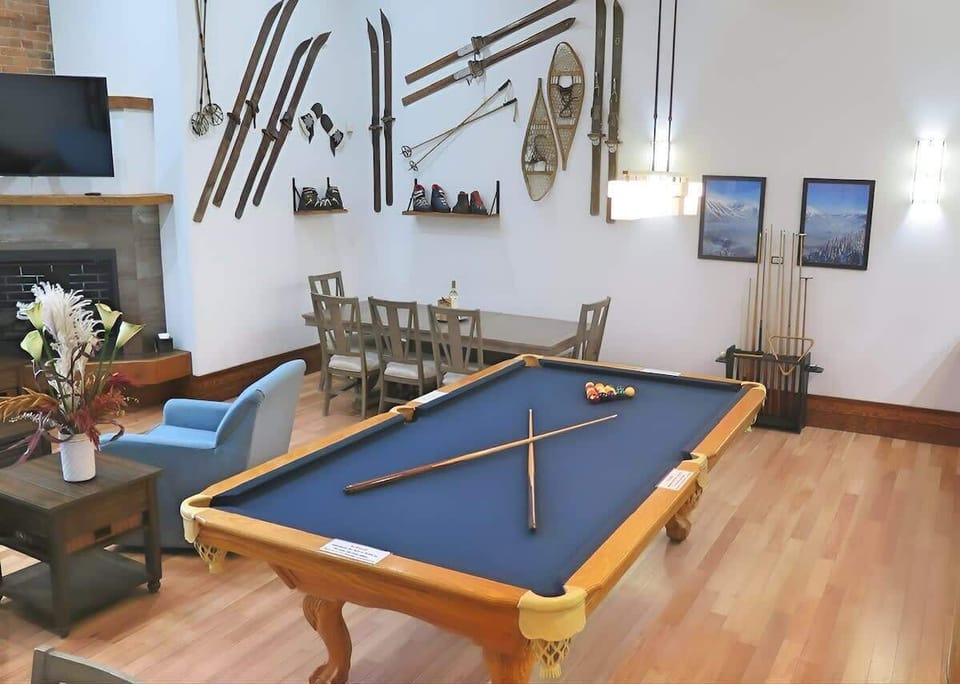Enjoy a game of pool in this stylish, ski-themed lounge area with fireplace.
