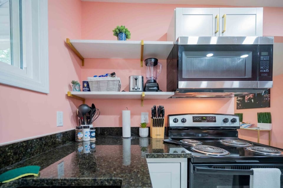 Explore our meticulously designed kitchen, fully stocked with essential cooking amenities for your convenience and culinary adventures.