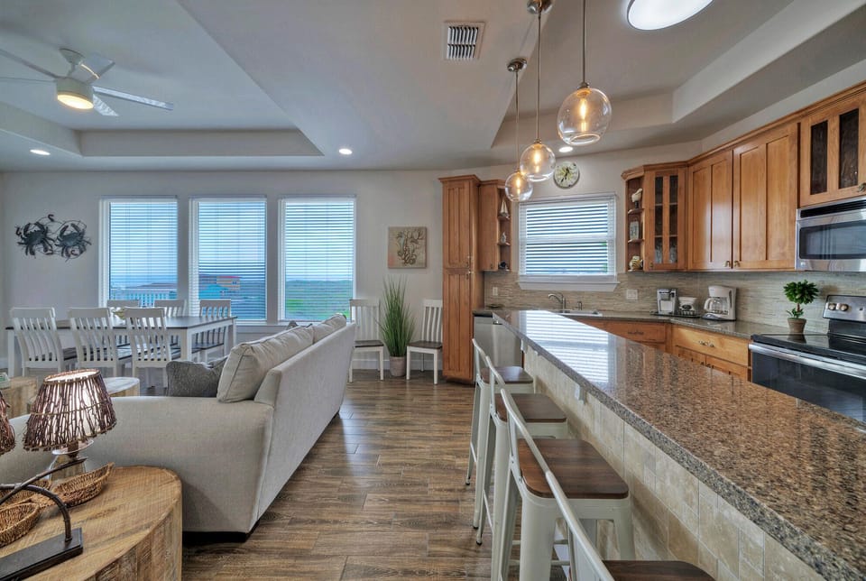 Kitchen features a counter with barstool seating.