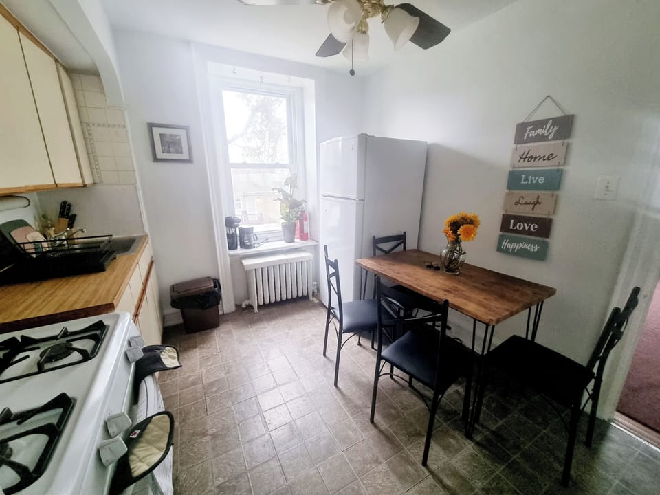 Step into a well-appointed kitchen designed for convenience. It includes a full-sized refrigerator, range, plenty of counter space for meal prep, and dining area. You'll find generous storage in the cabinetry, making it easy to keep things organized.