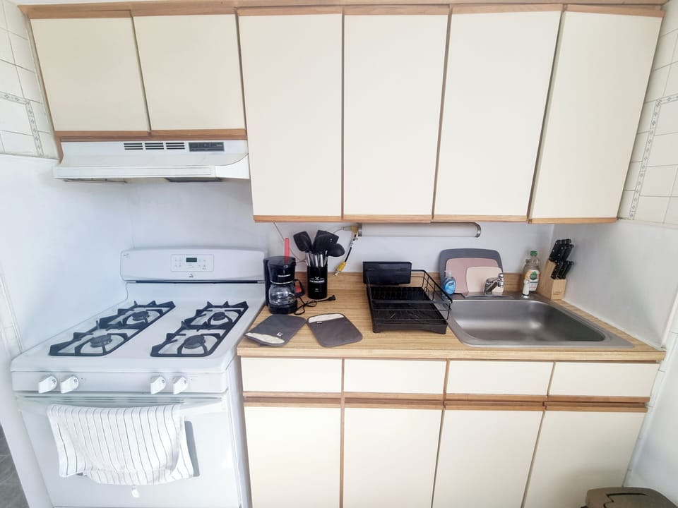 Step into a well-appointed kitchen designed for convenience. It includes a full-sized refrigerator, range, plenty of counter space for meal prep, and dining area. You'll find generous storage in the cabinetry, making it easy to keep things organized.
