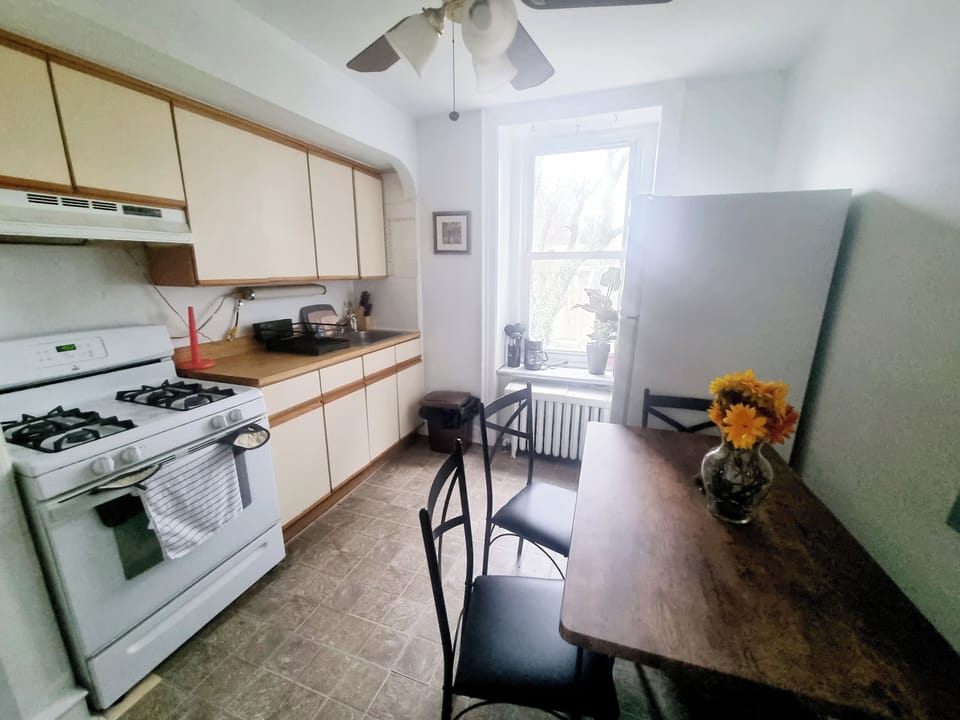Step into a well-appointed kitchen designed for convenience. It includes a full-sized refrigerator, range, plenty of counter space for meal prep, and dining area. You'll find generous storage in the cabinetry, making it easy to keep things organized.