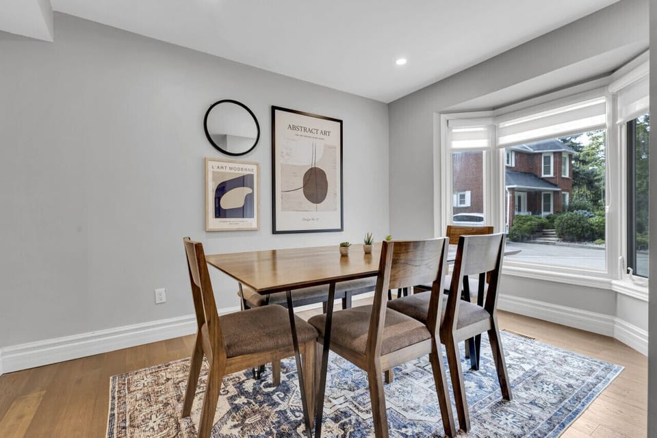 Well-lit dining room with contemporary design and window views.
