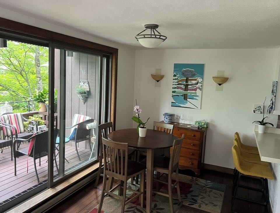 Kitchen table and kitchen counter with 3 bar stools.