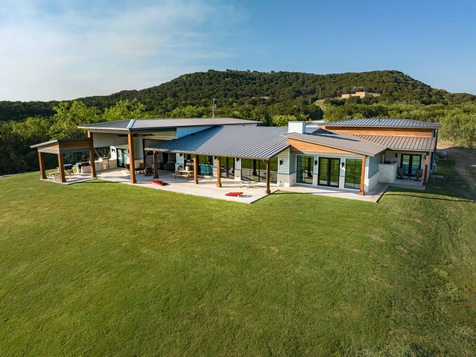 back yard where you can gather, grill and play cornhole