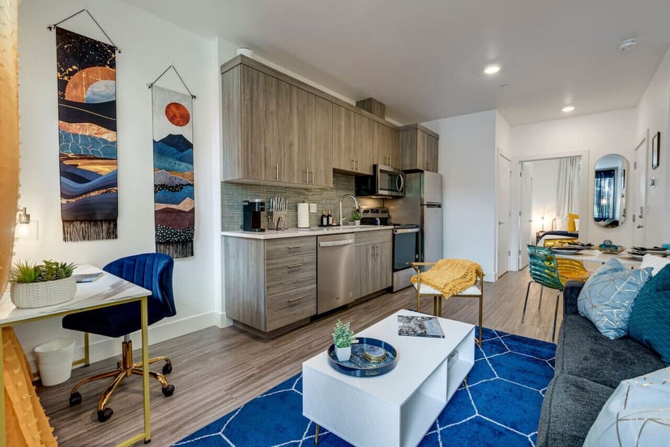The kitchen features stainless steel appliances, a gas range, a dishwasher, a microwave, an electric kettle, a coffee maker, a blender, and more!