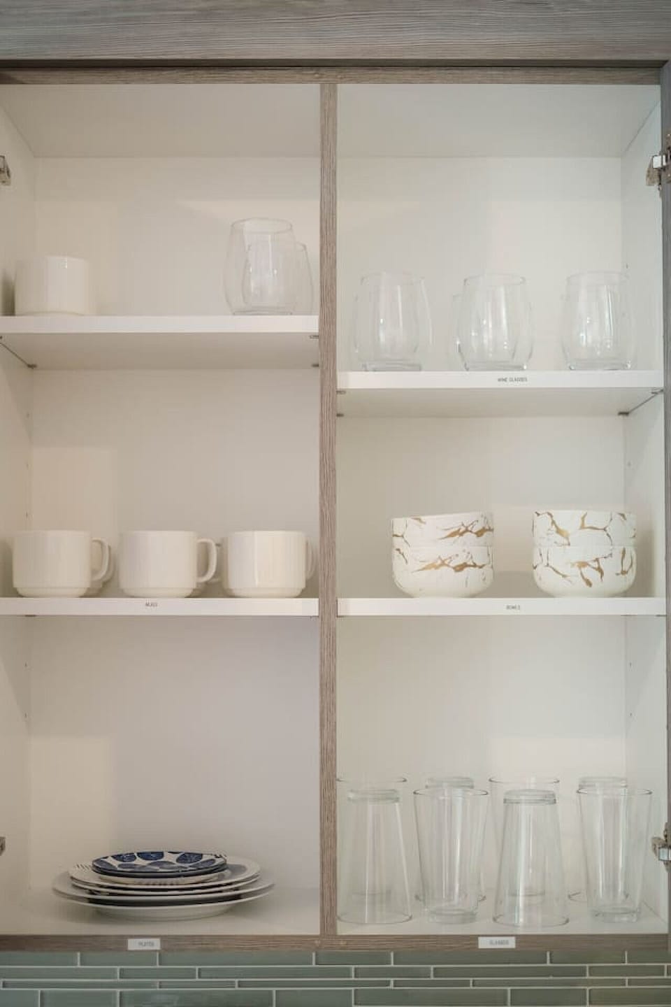 Complete set of dishes, flatware, tumblers, wine glasses and mugs.