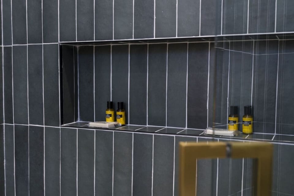 Dark vertical tile and clean lines give this bathroom a sleek, modern look.