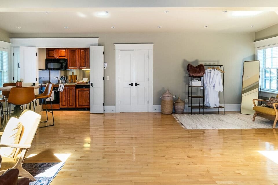 View of primary living space facing the kitchen and dressing areas.