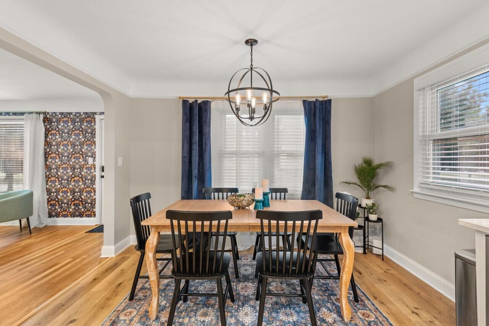 Feel the warmth of hardwood beneath your feet as you gather around the table in this inviting dining room oasis, complete with a stylish blue carpet that ties the room together. 🍽️✨