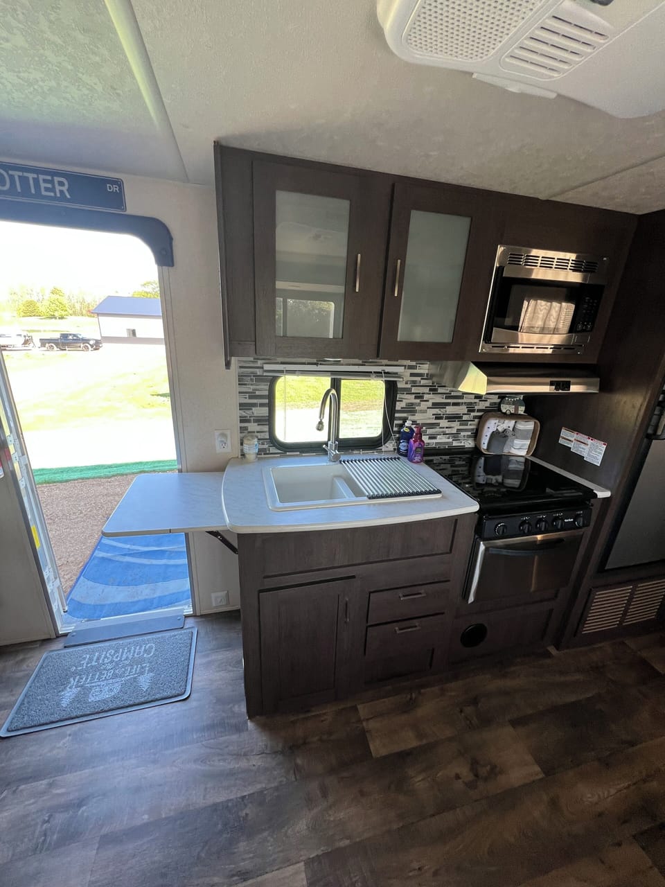 Full kitchen with 3 burner stove, oven, fridge with freezer, sink, microwave. 