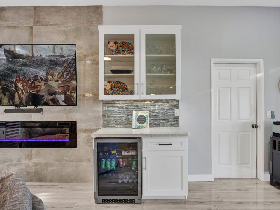 Beverage fridge and nice collection of drinking glasses for any type of beverage