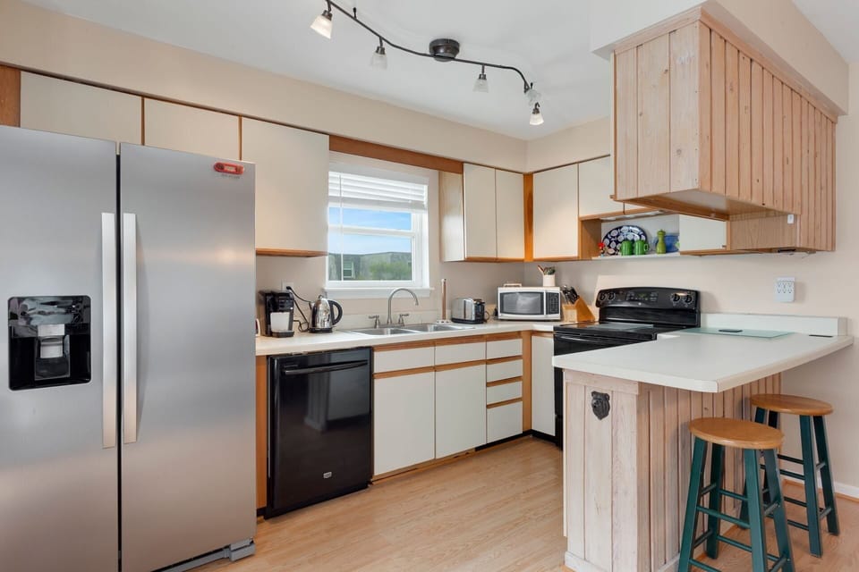 Whip up something delicious in the modern Kitchen to enjoy in the nearby dining area.