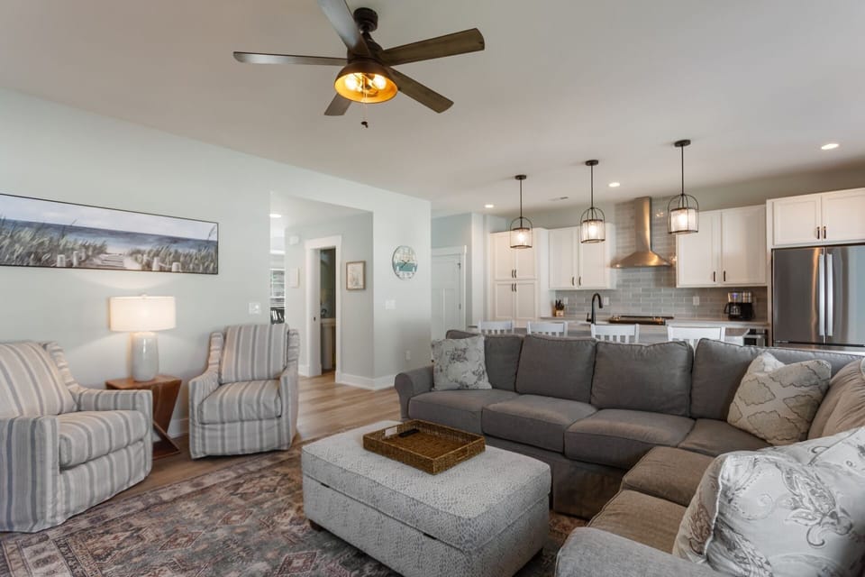 Relax after a fun day exploring the beach in the spacious Living Area with a large flat-screen TV and plenty of comfortable furniture for lounging.