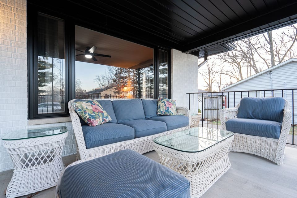 Covered front porch w/ comfy outdoor seating, ideal for group conversation
