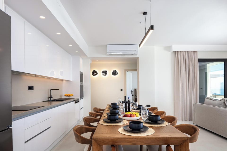 Adjacent to the kitchen is a spacious dining area with a large table that comfortably seats up to 12 guests.