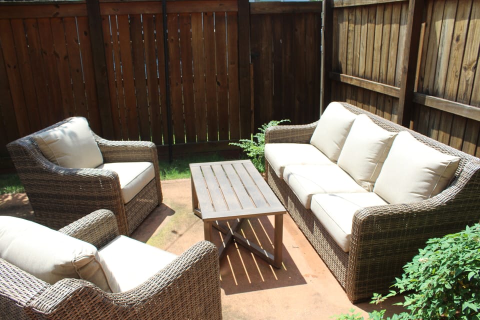 Private outdoor area with seating and lights