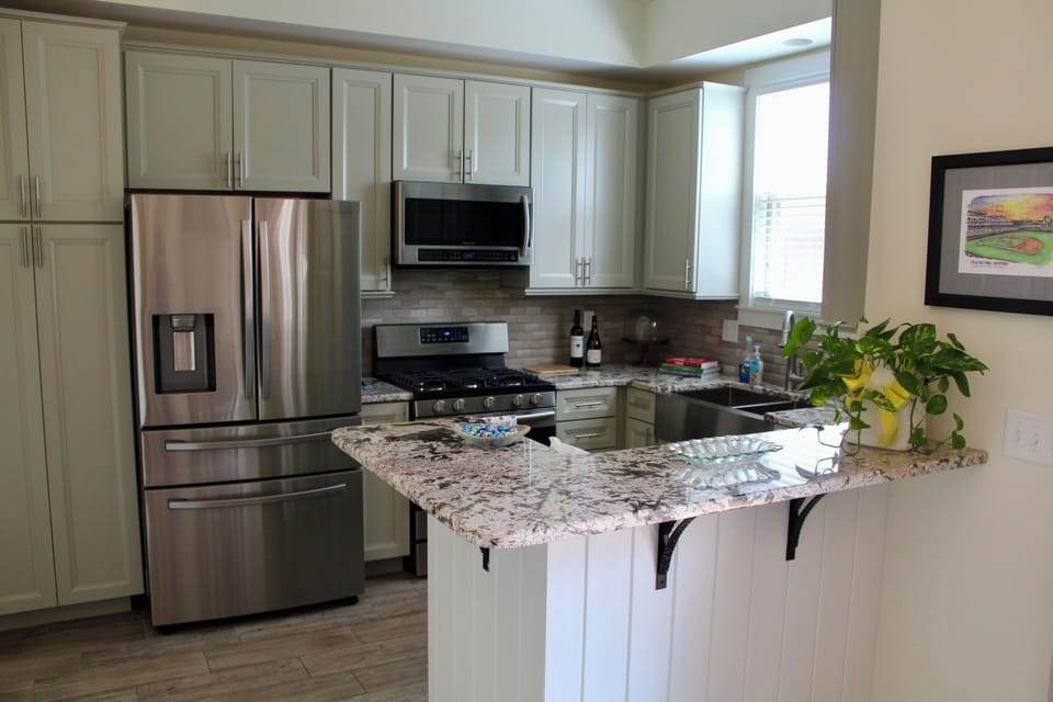 Kitchen includes pantry, refrigerator, gas top stove, microwave, and dishwasher