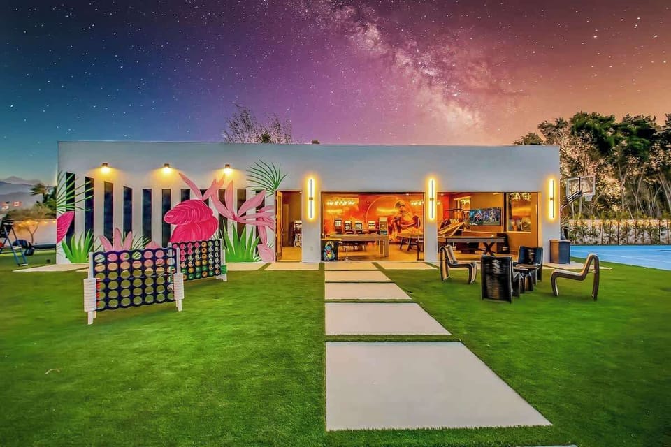 This vibrant pavilion is packed with oversized games like Connect Four and Jenga, surrounded by glowing string lights and expansive green space.