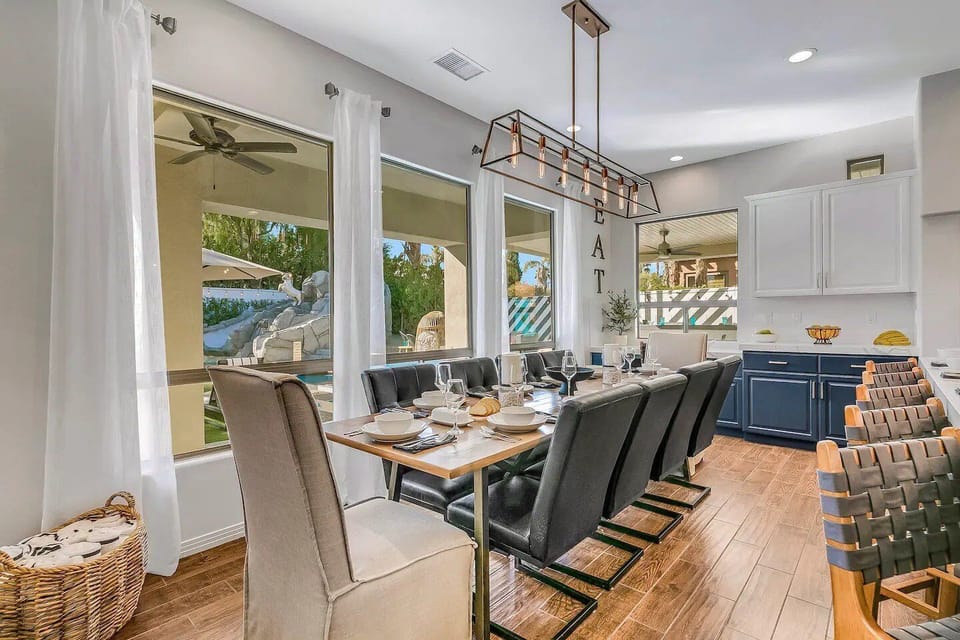 Elegant dining space with seating for ten, beautifully lit and open to the kitchen.