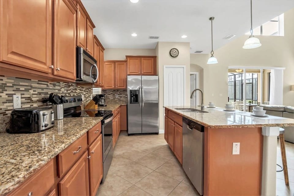 Fully Equipped Kitchen With Granite Countertops And Premium Appliances