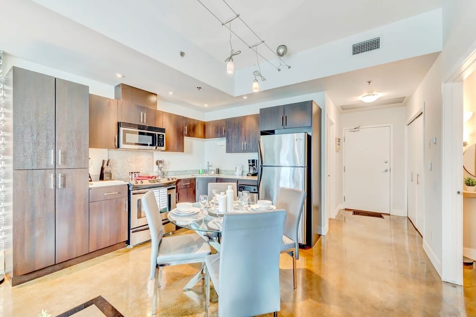 Spacious Kitchen With Modern Appliances And Dining Setup For Comfort