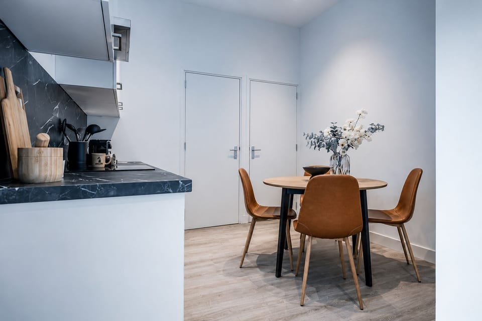 A calm and cozy shared dining space with cool tones, perfect for relaxed meals and quiet moments.